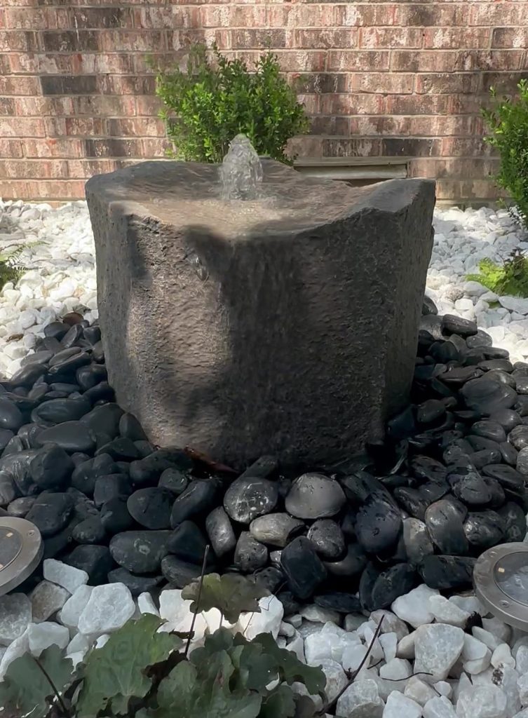 Mini water fountain surrounded with rocks